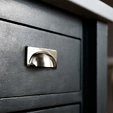 Polished Nickel Elm Cup Handle on Black Furniture