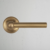 Antique Brass Harper Sprung Door Handle on White Background