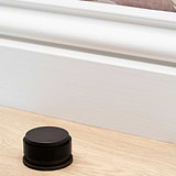 Bronze Seymour Door Stop on Wooden Floor