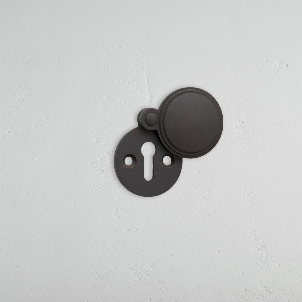 Bronze Warwick Covered Key Escutcheon on White Background