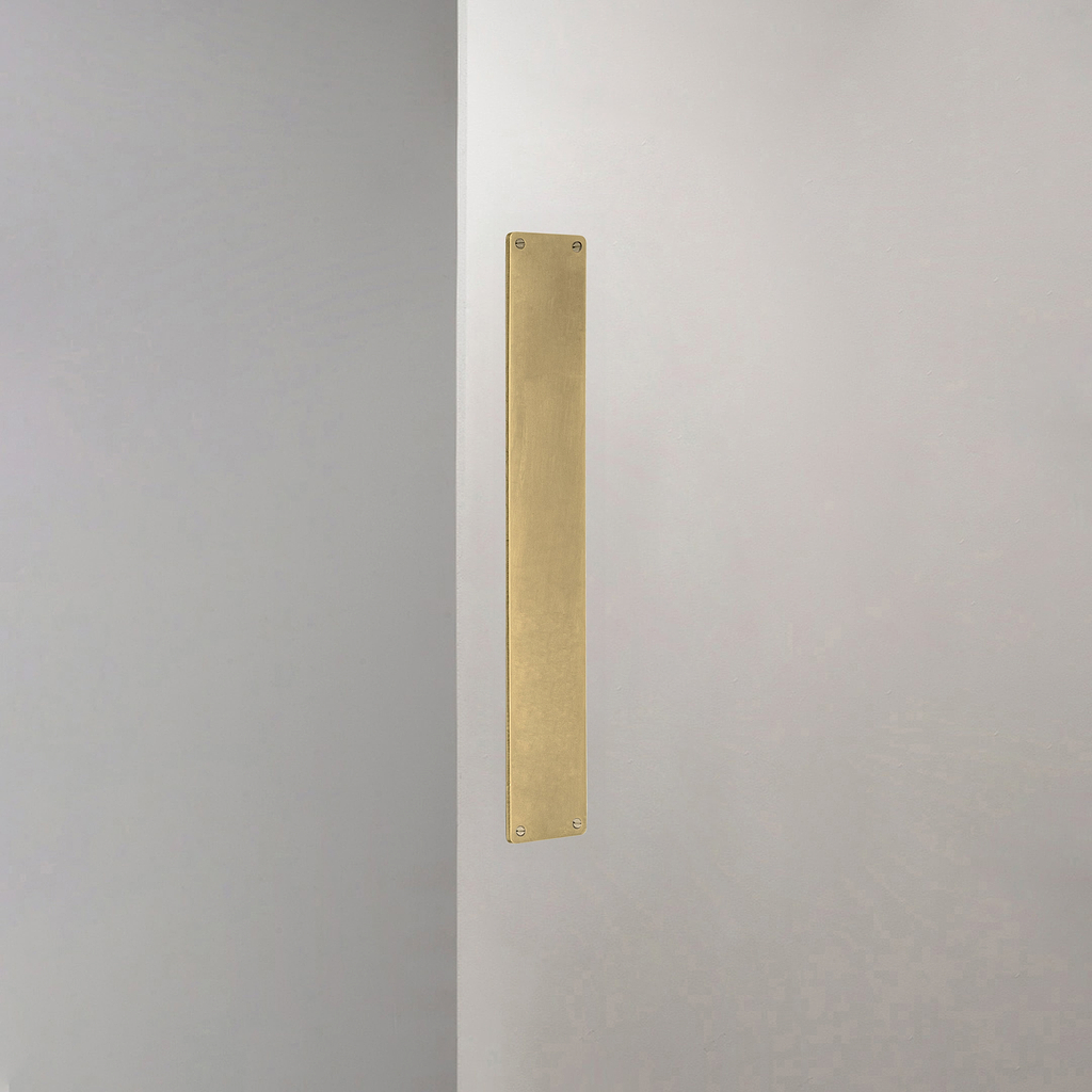Corston Push Plate in Antique Brass on White Background