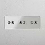 Multi-Level Six-Position Drievoudige Tuimelschakelaar in doorzichtig Gepolijst Nikkel - Hoogwaardig verlichtingsbedieningsaccessoire op witte achtergrond