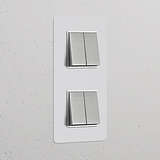 Vertikaler Doppelrahmen mit 4 Kippschaltern; lackierbar in Nickel glänzend und weiß; modernes und vielseitiges Design.
