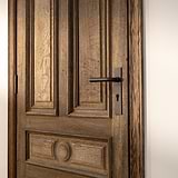 Apsley gefederter Türgriff langes Schild + Euro-Schloss in Bronze an einer Holztür mit verzierten Paneelen.
