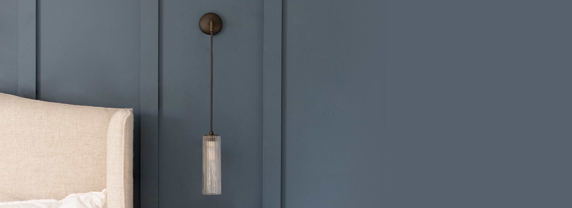 Bronze pendant wall light with fluted glass by Corston bedside