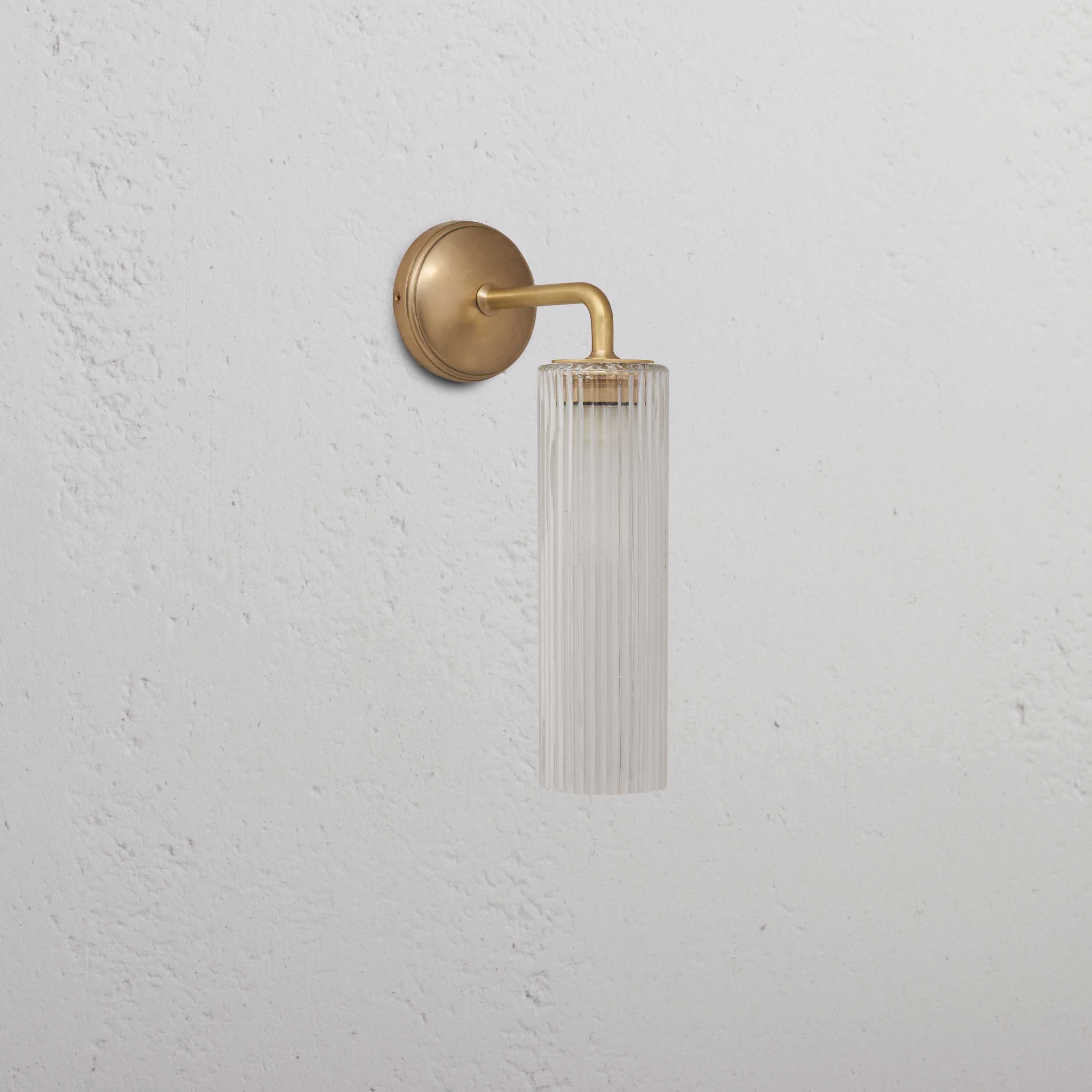 Claremont Small Wall Light with fluted glass in antique brass finish, combining elegance and modern design.