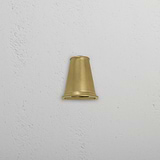 Small wall light named 'Southwark Mast Light – Antique Brass' mounted on a white textured wall.