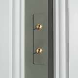 Close-up of a 2G architrave two-way toggle switch with paintable antique brass finish.