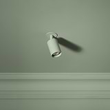 Brompton Spotlight 50mm - Paintable spotlight on green background, ideal for blending into room decor with paintable finish.