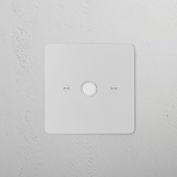 Paintable white 1G socket module on a textured white wall, designed to blend seamlessly into surroundings.