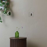 1G Double Pole Rocker Switch in Polished Nickel White on a beige wall, part of the 1G Switches & Dimmers collection.
