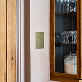 Antique brass 6G two-way toggle switch on beige wall, part of 6G Switches & Dimmers collection.