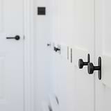 Bronze Kilburn Furniture Knob on a cabinet door, showcasing sleek design and elegance for furniture enhancement.