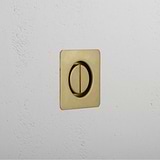 Square antique brass door handle set in a white textured wall.