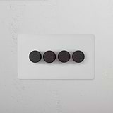 4G Dimmer Switch - Paintable Bronze on a white textured wall, featuring four sleek and modern dimmers.