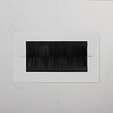 Double Module Brush Plate in Paintable Black finish for 2G Sockets & Modules, mounted on a textured white wall.