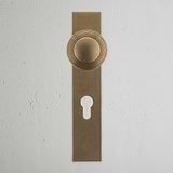 Poplar Long Plate Sprung Door Knob & Euro Lock in antique brass, featuring a circular knob and keyhole for classic style.