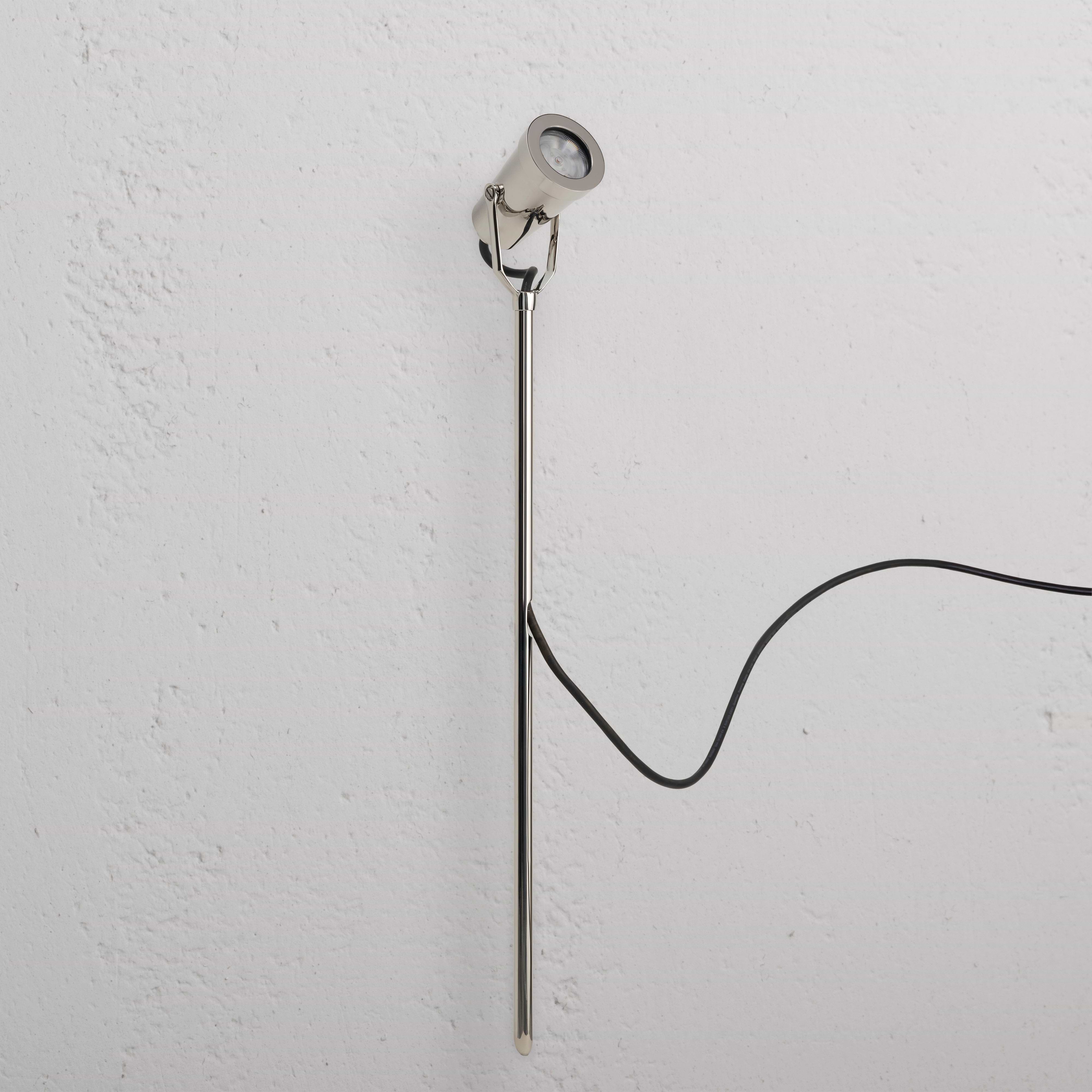 Cambridge Ground Spotlight 24V in polished nickel, a sleek outdoor spotlight with black power cord attached.