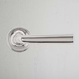 Clayton Fixed Door Handle in polished nickel, mounted on a white textured wall.