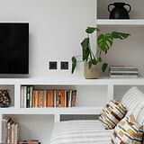 Bronze Black 1G single socket UK outlet on a wall, complementing the room's sleek and minimalist design.