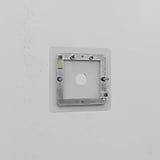 Clear 1G switch plate for a single light switch, mounted on a white wall. Sleek and transparent design.