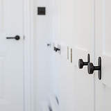 Bronze Kilburn Furniture Knob on a cabinet door, showcasing sleek design and elegance for furniture enhancement.