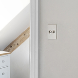 2G Two Way Toggle Slimline Switch in polished nickel on a white wall with wood beam and cabinet background.