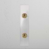 Clear antique brass 2G architrave two-way toggle switch on a white wall, part of the 2G switches & dimmers collection.