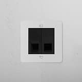 Paintable black 2x CAT6 socket, aligning with 1G sockets & modules, on a white textured wall.