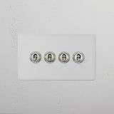 4G Two Way Toggle Switch in paintable polished nickel finish, featuring four round switches on a white wall plate.