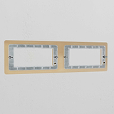 Antique Brass 4G 100mm Module Plate, a sleek brass module frame for electrical outlets on a white wall.