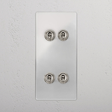 4G Vertical Toggle Switch in Clear Polished Nickel on a white plate at a pristine wall.