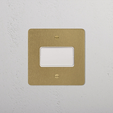 Fan Isolator Switch, Antique Brass White finish, on a textured white wall.