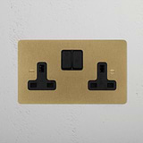 antique brass designer double socket beside plants