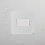 Paintable white fan isolator switch on a textured white wall, designed to blend seamlessly with any decor.