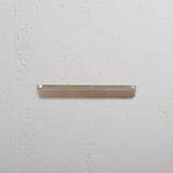 Antique brass Oxford Furniture Handle 128mm, small pull handle on a textured white background.