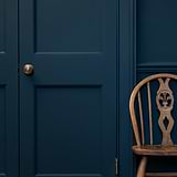 Antique Brass Poplar Unsprung Door Knob on a closed blue door, part of the Door Handles collection.