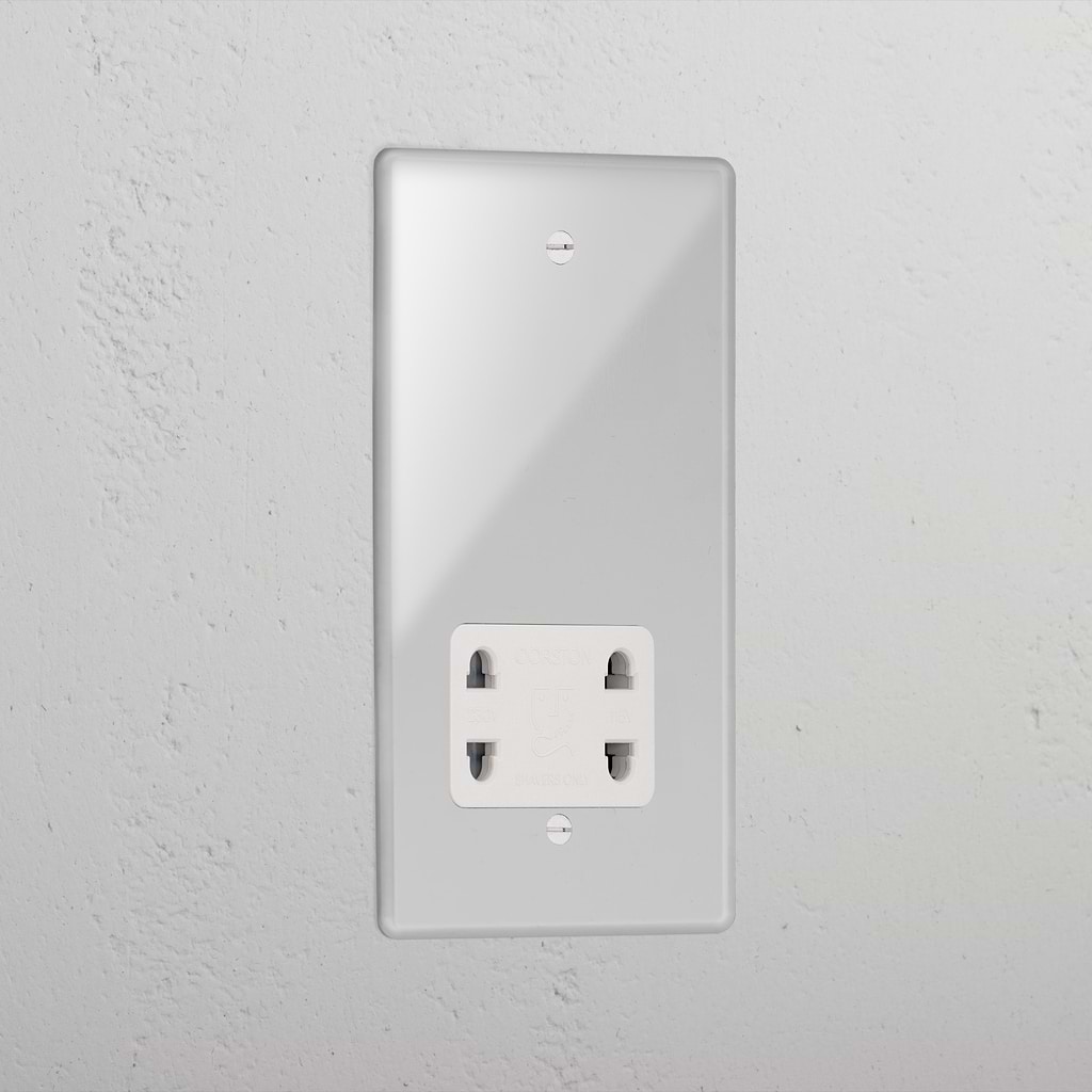 Transparent shaver socket with white insert on grey wall. 