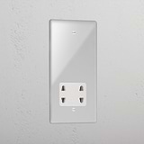 Transparent shaver socket with white insert on grey wall. 