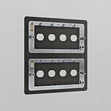 Bronze 8G switch plate made of brass, mounted on a white wall, intended for multiple switch configurations.