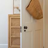 Bronze Canning Thumbturn hardware accessory, shown installed on a door.