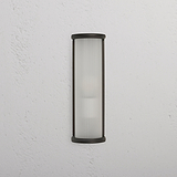 Medium Bank Wall Light Fluted Glass – Bronze with frosted ribbed glass and bronze frame on a white wall.