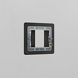 1G 25mm bronze brass module plate for switches, elegantly mounted on a white wall.