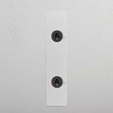 2G Architrave Two Way Toggle Switch in paintable bronze finish with two toggle switches on a sleek rectangular panel.