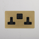 antique brass designer double socket beside plants