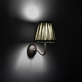 Small Malvern Wall Light in Deep Green at an angle and turned on at night