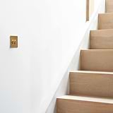 Antique brass 2G retractive toggle switch on a white wall, designed for use with 2G switches and dimmers.