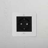 Paintable Black Schuko Socket, 1G Sockets & Modules on white wall for customizable home electrical solutions.