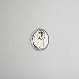 Polished Nickel Canning Key Escutcheon On White Background