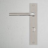 Polished nickel Apsley Long Plate door handle with thumbturn, mounted on a white background.